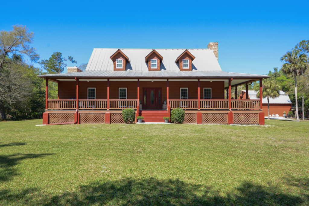 Front of 2-story house in Florida with wraparound porch