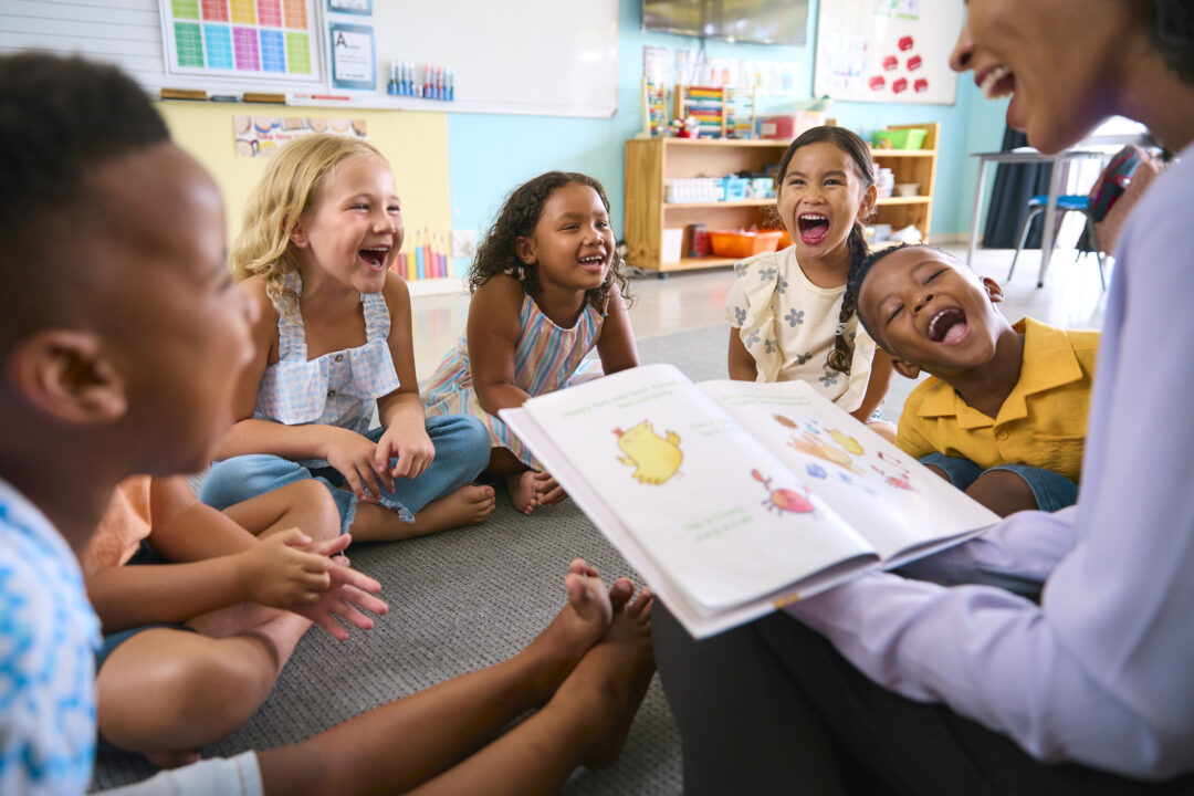 Seminole County School Students and Teacher Reading a book and laughing.jpg